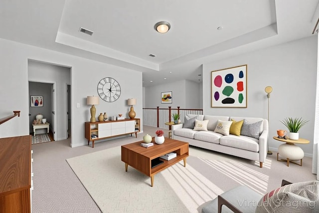409 Dycus Bnd, Liberty Hill, TX 78642 - carpeted living area with a raised ceiling and baseboards