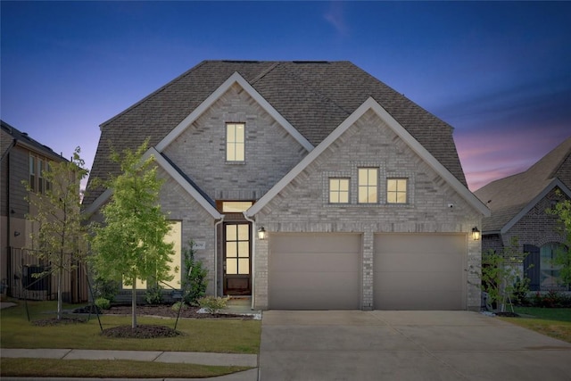 409 Dycus Bnd, Liberty Hill, TX 78642 - view of front of property featuring driveway, a garage, roof with shingles, and brick siding