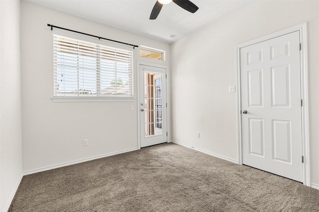 empty room featuring baseboards, carpet, and ceiling fan