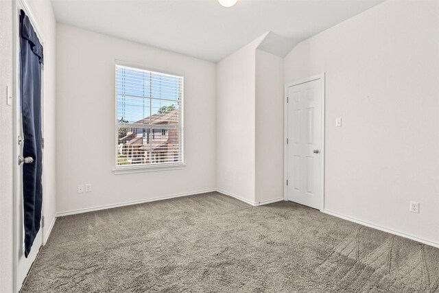 carpeted spare room with baseboards