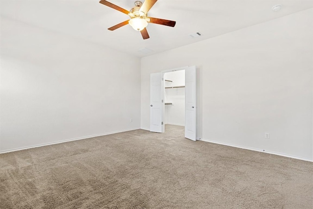 spare room with visible vents, baseboards, carpet flooring, and ceiling fan