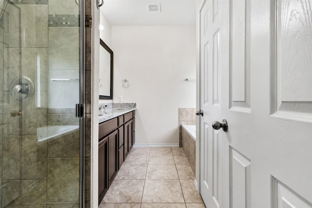 full bath with tile patterned flooring, visible vents, vanity, a garden tub, and a stall shower