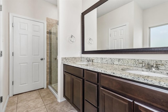 bathroom featuring a sink, double vanity, and a stall shower