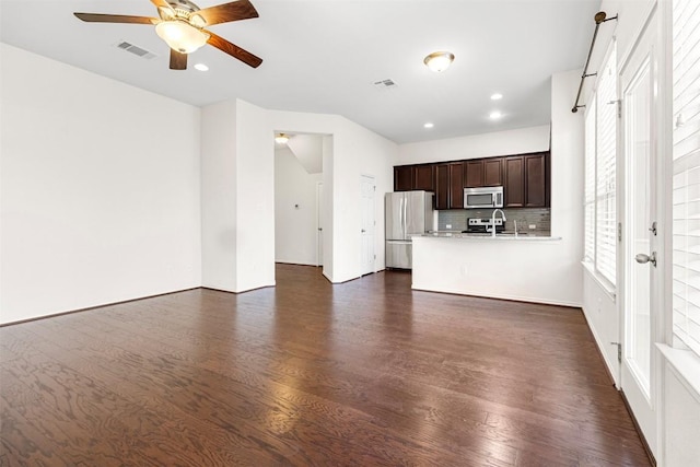 unfurnished living room featuring dark wood finished floors, ceiling fan, visible vents, and recessed lighting