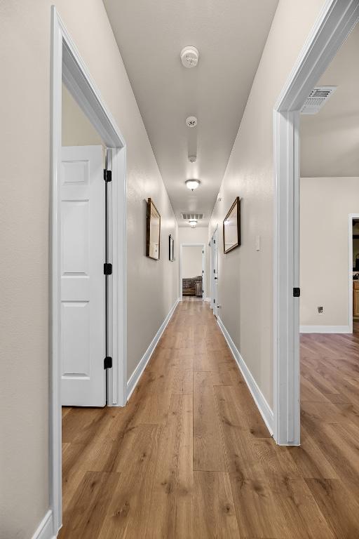 125 Brahman Ct, Bastrop, TX 78602 - hall with wood finished floors and baseboards