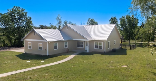 125 Brahman Ct, Bastrop, TX 78602 - ranch-style home featuring a front yard and metal roof
