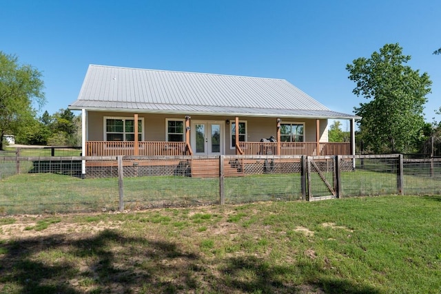 125 Brahman Ct, Bastrop, TX 78602 - farmhouse inspired home with a porch, french doors, and metal roof