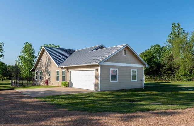 125 Brahman Ct, Bastrop, TX 78602 - view of home's exterior with driveway, an attached garage, a lawn, and metal roof
