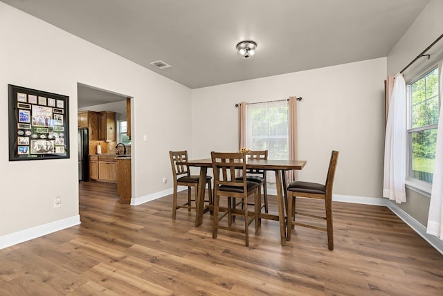 dining room with visible vents, baseboards, and dark wood finished floors