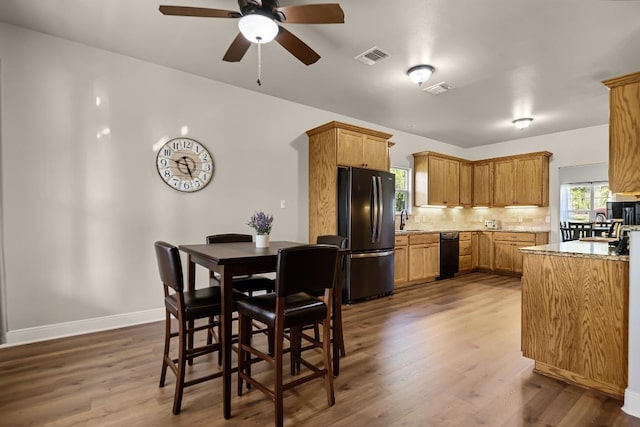 125 Brahman Ct, Bastrop, TX 78602 - dining area featuring ceiling fan, dark wood-style floors, and baseboards
