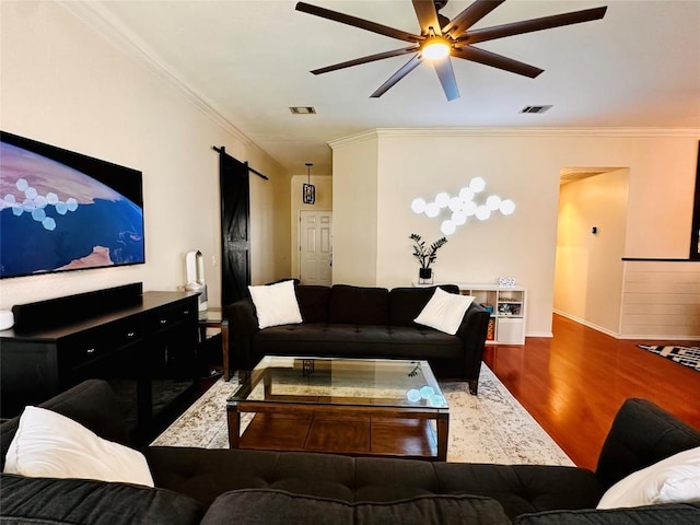 16903 Isle Of Man Rd, Pflugerville, TX 78660 - living area with ceiling fan, wood finished floors, crown molding, baseboards, and a barn door