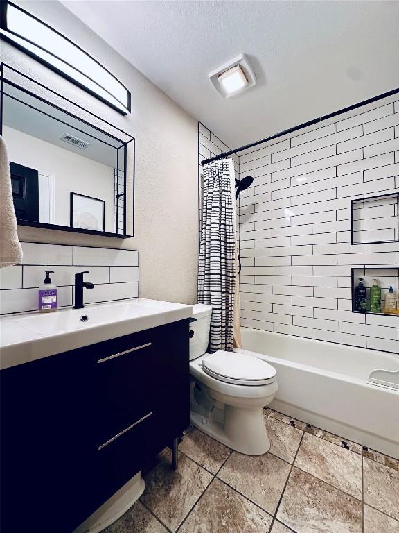 16903 Isle Of Man Rd, Pflugerville, TX 78660 - bathroom featuring vanity, toilet, shower / bathtub combination with curtain, and tile patterned flooring