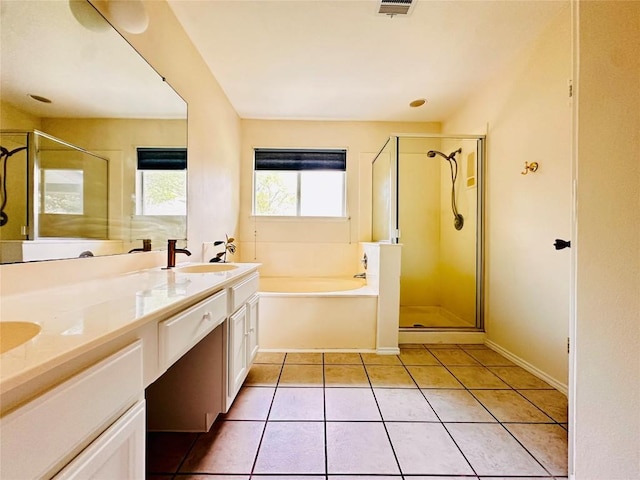16903 Isle Of Man Rd, Pflugerville, TX 78660 - bathroom with a bath, a stall shower, double vanity, and tile patterned floors