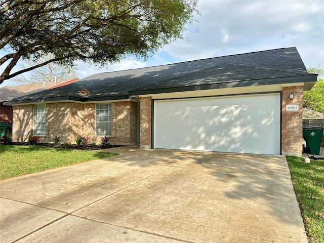 16903 Isle Of Man Rd, Pflugerville, TX 78660 - single story home with brick siding, a shingled roof, an attached garage, concrete driveway, and a front lawn