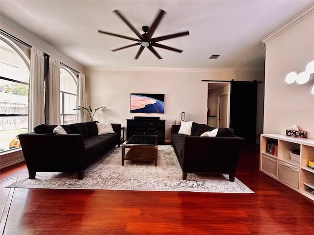 16903 Isle Of Man Rd, Pflugerville, TX 78660 - living area featuring a barn door, a ceiling fan, wood finished floors, and crown molding