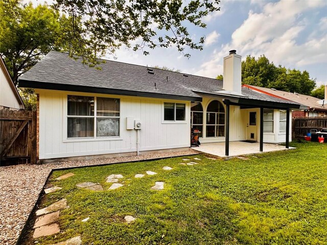 16903 Isle Of Man Rd, Pflugerville, TX 78660 - rear view of house featuring a patio area, a chimney, and a shingled roof