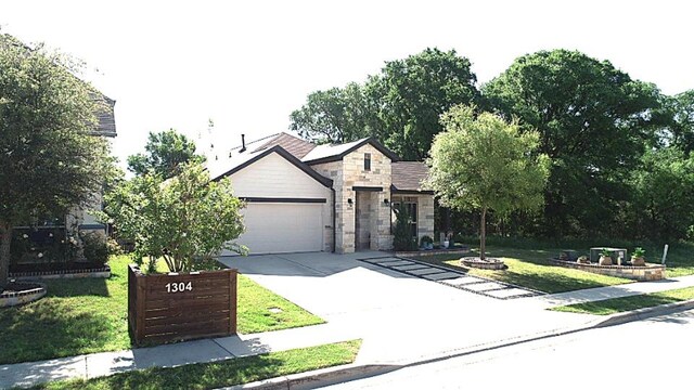 1300 Goldilocks Ln, Manchaca, TX 78652 - view of front of property with an attached garage, a front lawn, driveway, and stone siding