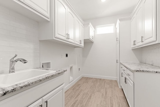 112 Vista De Luna Ln, Belton, TX 76513 - washroom featuring electric dryer hookup, cabinet space, light wood-style floors, and washer hookup