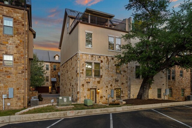 1013 Highknoll Ln, Georgetown, TX 78628 - property at dusk with uncovered parking