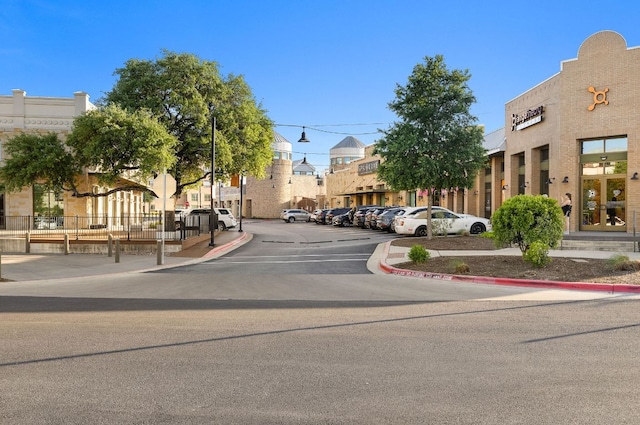 1013 Highknoll Ln, Georgetown, TX 78628 - view of asphalt street featuring street lights, curbs, traffic signs, and sidewalks