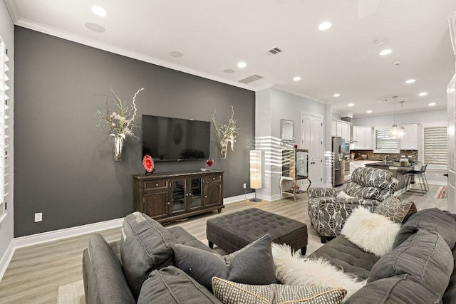 1013 Highknoll Ln, Georgetown, TX 78628 - living room with crown molding, recessed lighting, and light wood-style floors