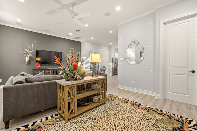1013 Highknoll Ln, Georgetown, TX 78628 - living room with crown molding, light wood-style floors, recessed lighting, and ceiling fan