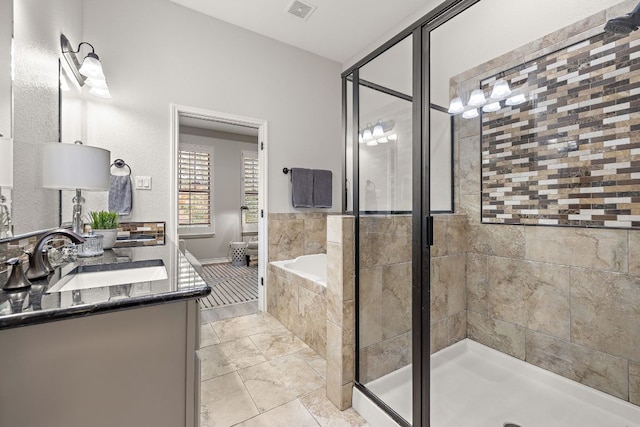 1013 Highknoll Ln, Georgetown, TX 78628 - bathroom with double vanity, a garden tub, a shower stall, and tile patterned floors