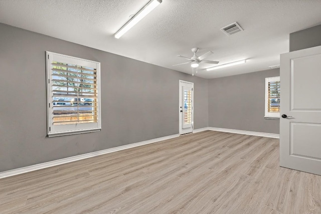 1013 Highknoll Ln, Georgetown, TX 78628 - spare room featuring light wood-style floors, a textured ceiling, and ceiling fan