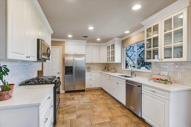 8007 Davis Mountain Cv, Austin, TX 78726 - kitchen featuring stainless steel appliances, a sink, stone finish flooring, tasteful backsplash, and recessed lighting