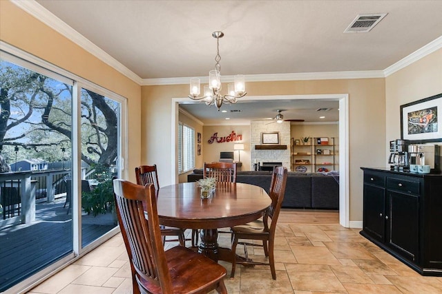 8007 Davis Mountain Cv, Austin, TX 78726 - dining area featuring a chandelier, a fireplace, ceiling fan, and ornamental molding