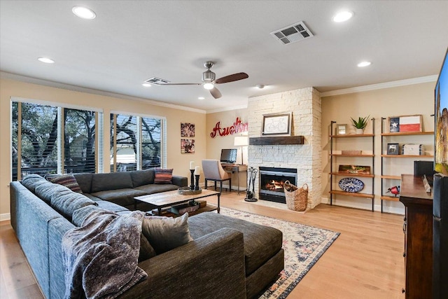 8007 Davis Mountain Cv, Austin, TX 78726 - living room with a ceiling fan, crown molding, a fireplace, light wood-style floors, and recessed lighting