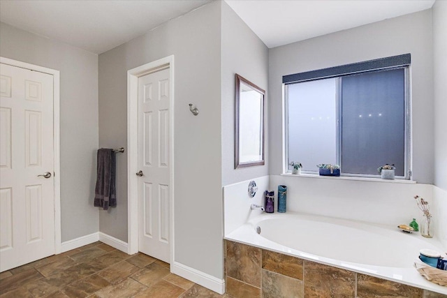 8007 Davis Mountain Cv, Austin, TX 78726 - full bath with a garden tub, stone finish flooring, and baseboards