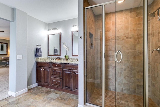 8007 Davis Mountain Cv, Austin, TX 78726 - full bathroom with double vanity, a stall shower, baseboards, and stone finish floors