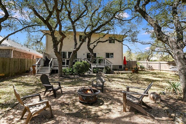 8007 Davis Mountain Cv, Austin, TX 78726 - rear view of house with a fire pit, a fenced backyard, a wooden deck, and stairway