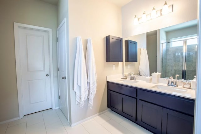 188 Catalina Dr, Kyle, TX 78640 - full bathroom with a sink, baseboards, a shower stall, and double vanity