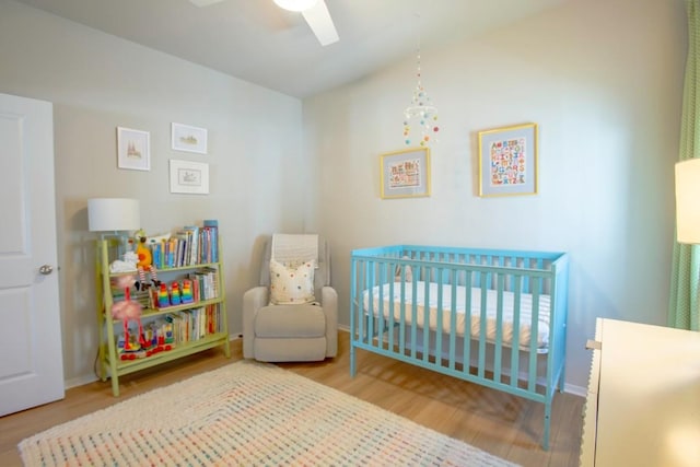 188 Catalina Dr, Kyle, TX 78640 - bedroom with baseboards, a crib, wood finished floors, and lofted ceiling