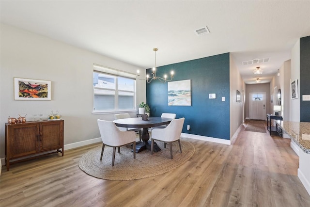 353 Cherry Laurel Ln, Kyle, TX 78640 - dining space featuring light wood finished floors, a chandelier, and baseboards