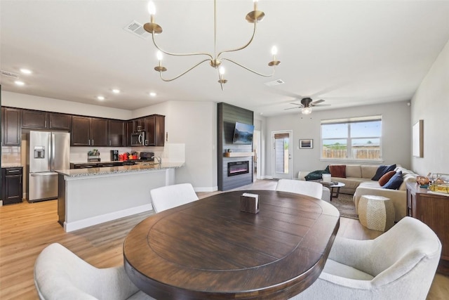 353 Cherry Laurel Ln, Kyle, TX 78640 - dining room featuring ceiling fan, light wood-style flooring, recessed lighting, and a chandelier