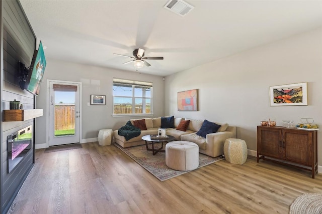 353 Cherry Laurel Ln, Kyle, TX 78640 - living area featuring light wood-style floors, ceiling fan, and baseboards