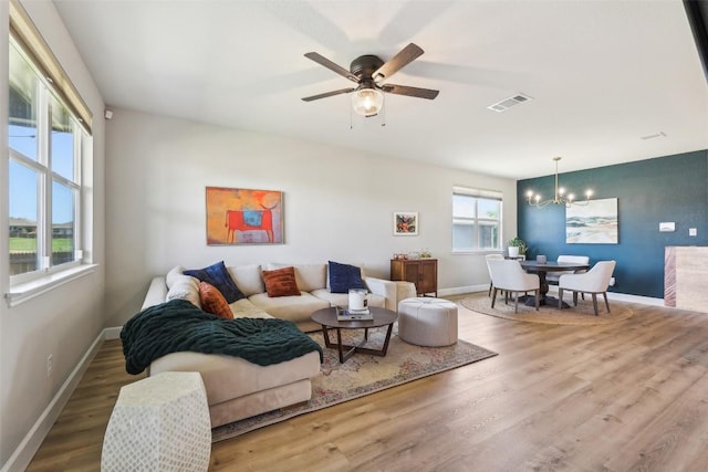 353 Cherry Laurel Ln, Kyle, TX 78640 - living area featuring a chandelier, wood finished floors, ceiling fan, and baseboards