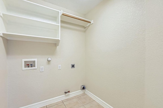 8404 Cahill Dr, Austin, TX 78729 - laundry area with hookup for a gas dryer, baseboards, hookup for a washing machine, light tile patterned floors, and electric dryer hookup