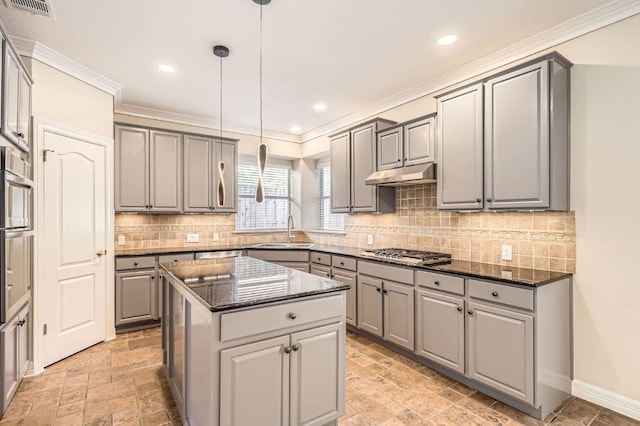 8404 Cahill Dr, Austin, TX 78729 - kitchen with gray cabinets, a sink, stainless steel gas cooktop, a kitchen island, and ornamental molding