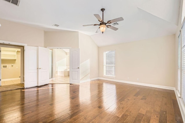 8404 Cahill Dr, Austin, TX 78729 - unfurnished bedroom featuring vaulted ceiling, light wood finished floors, baseboards, ensuite bathroom, and a ceiling fan