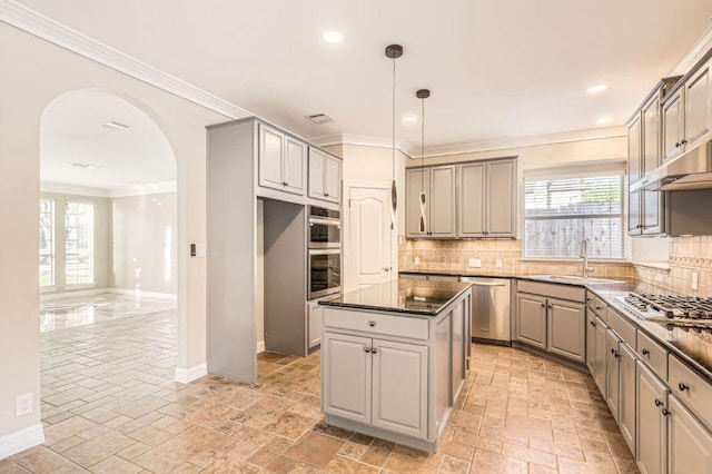 8404 Cahill Dr, Austin, TX 78729 - kitchen featuring gray cabinetry, a sink, appliances with stainless steel finishes, arched walkways, and tasteful backsplash