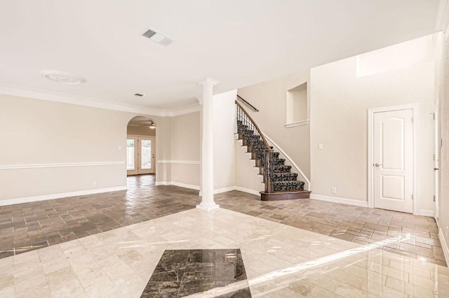 8404 Cahill Dr, Austin, TX 78729 - entrance foyer with stone tile floors, arched walkways, stairway, baseboards, and crown molding
