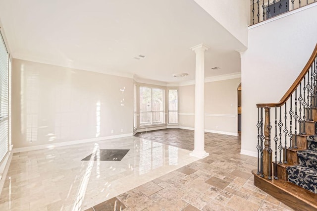 8404 Cahill Dr, Austin, TX 78729 - entrance foyer with ornate columns, baseboards, crown molding, stairway, and arched walkways