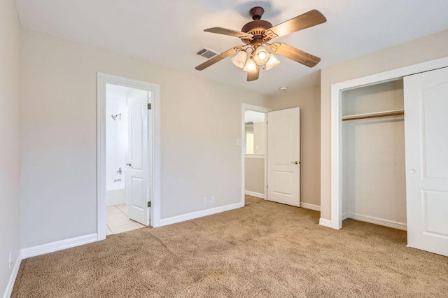 8404 Cahill Dr, Austin, TX 78729 - unfurnished bedroom featuring light carpet, a closet, ensuite bathroom, baseboards, and ceiling fan