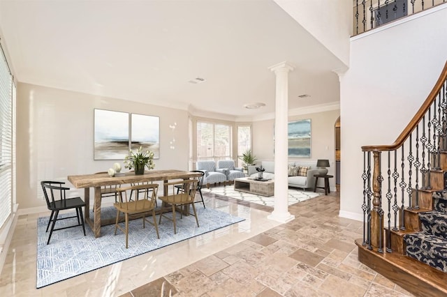 8404 Cahill Dr, Austin, TX 78729 - dining area featuring stairway, decorative columns, baseboards, crown molding, and stone tile floors