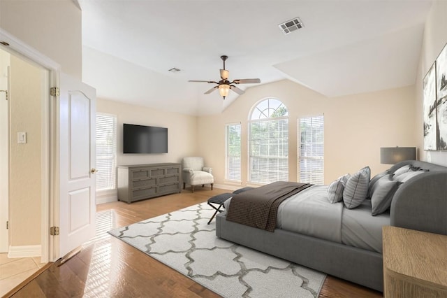 8404 Cahill Dr, Austin, TX 78729 - bedroom with lofted ceiling, wood finished floors, baseboards, and ceiling fan
