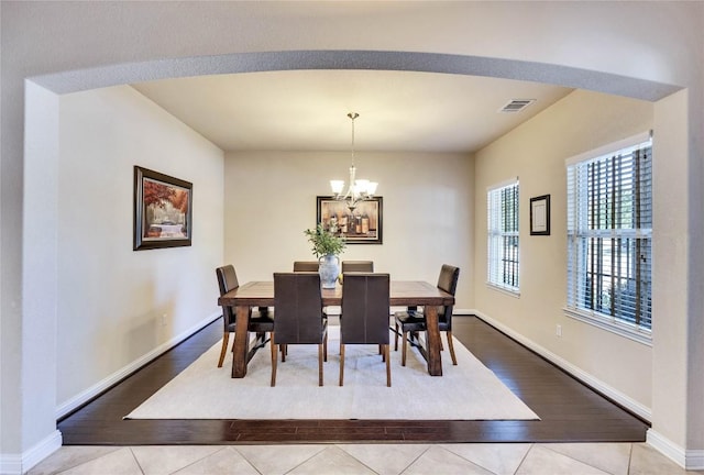4829 Pyrenees Pass, Austin, TX 78738 - dining area featuring a chandelier and wood finished floors